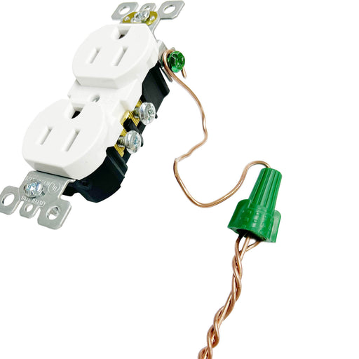Electrician utilizing a green wire nut for a secure connection in an electrical outlet