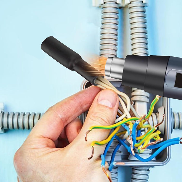 Hand using a tool to work on electrical wiring against a light blue background